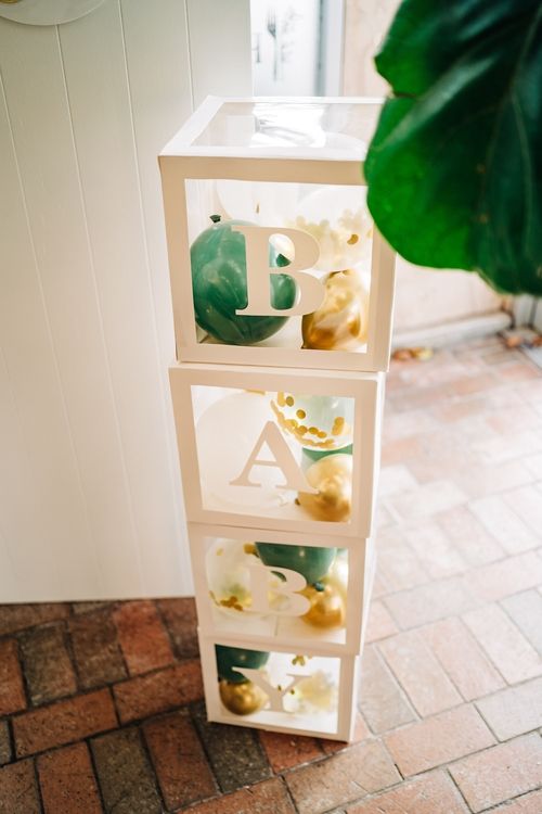 Decorative white stacked boxes with green and gold accents.