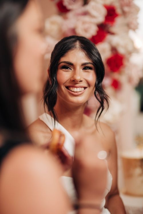 Romantic portrait with floral backdrop featuring red and cream roses.
