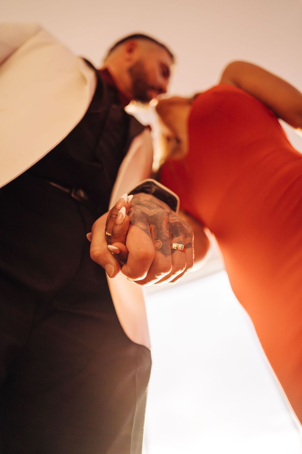 Close up artistic shot of engaged couple's hands with ring.