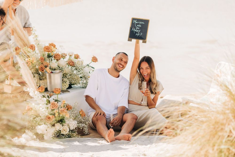 A proposal celebration on the sand — Marissa will you marry me?