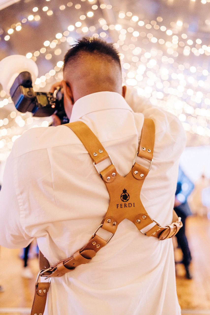 A playful wedding moment captured with the couple and their friends.